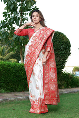 THIS EXQUISITE WORK OF ART IN BANARASI SILK FEATURES INTRICATE FLORAL DETAILS AND ZARI ON ALL FOUR SIDES SAREE