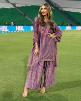 'Grace in Lavender Woman in Embroidered Traditional Outfit at the Stadium'